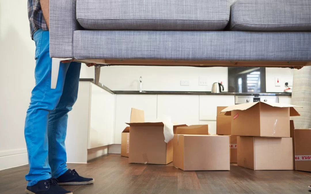 Man-Carrying-Sofa-When-Moving-into-New-House-1080x675