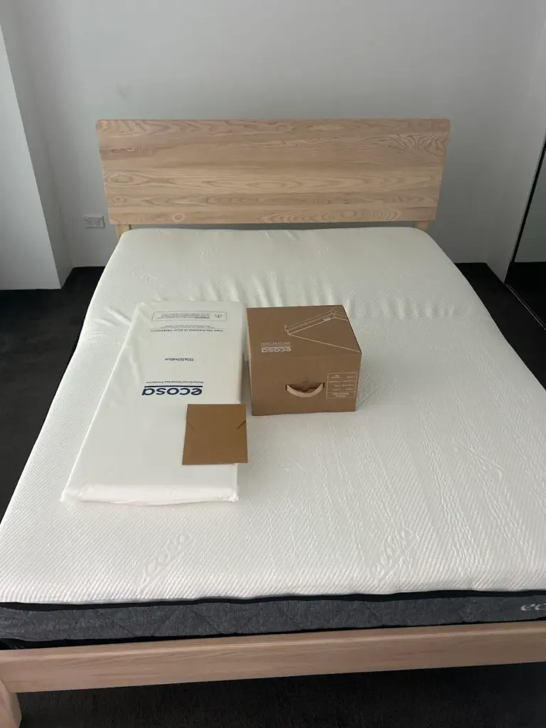 A bed frame and mattress set up in a bedroom